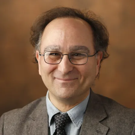 a smiling person wearing a suit 