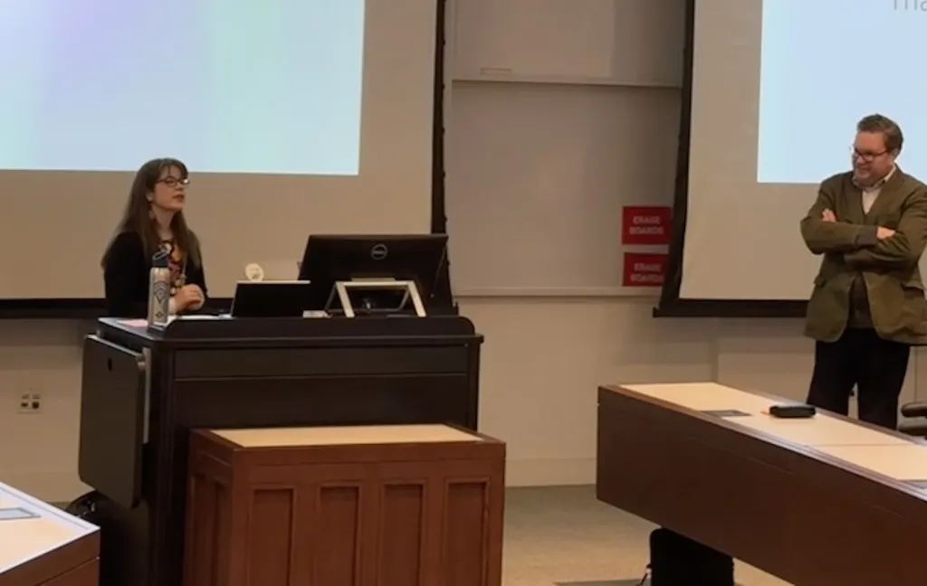 two professors standing in front of an audience