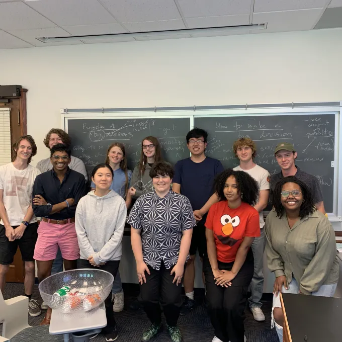 a group of students posing for a photo in a classroom